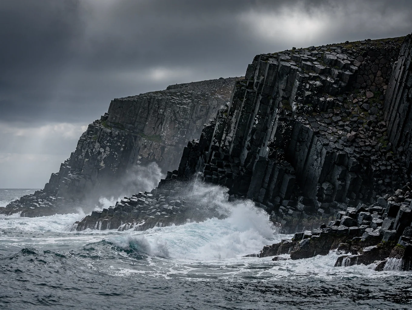 Black volcanic sea stacks rising from stormy coastal surf