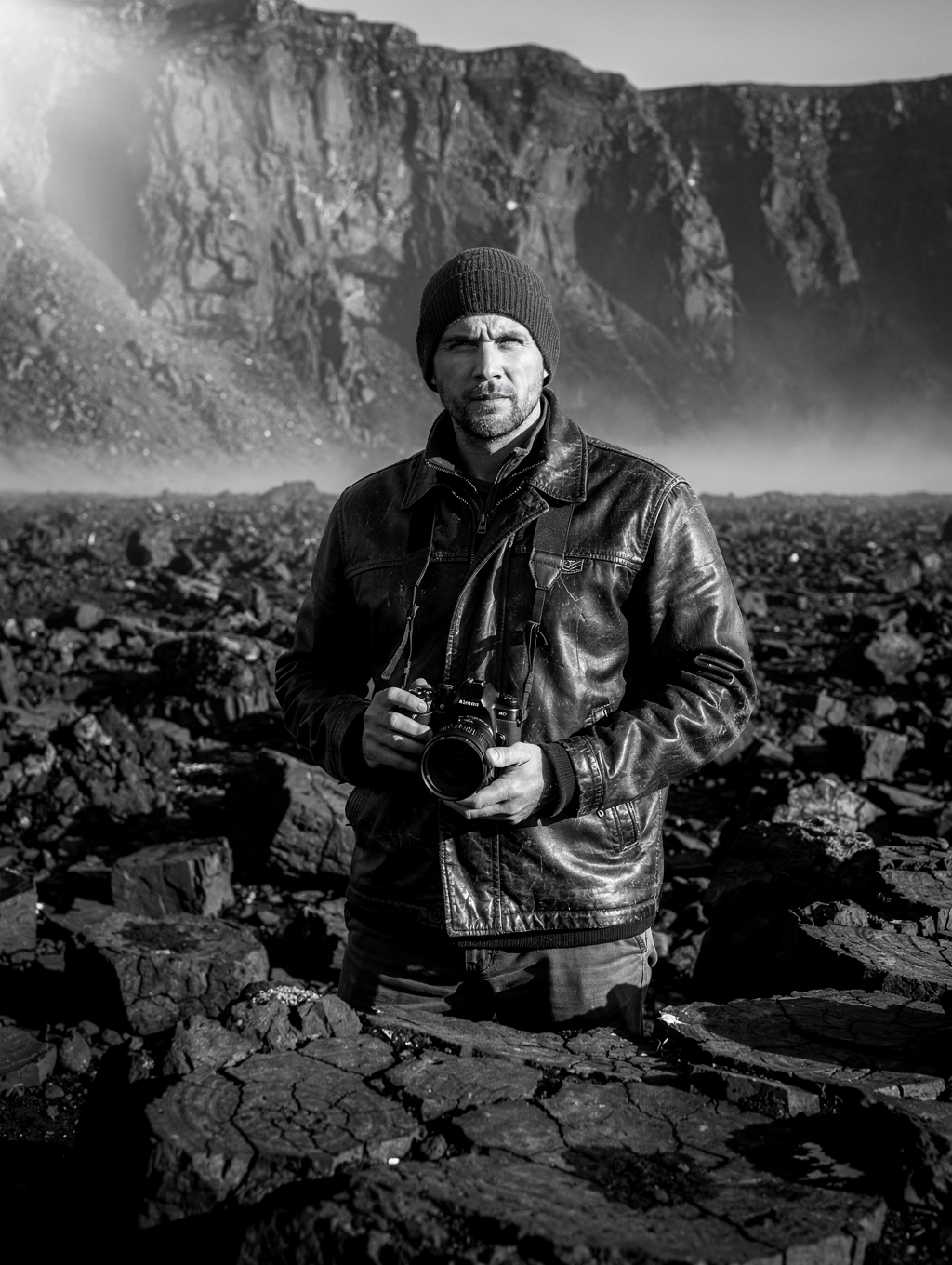Photographer standing on volcanic basalt in Iceland